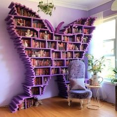 a purple butterfly shaped book shelf in the corner of a room