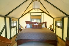 a bed in a room with wooden floors and walls