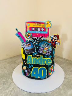 there is a cake that looks like an old school radio and cassette tape recorder on top