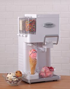 an ice cream dispenser with two scoops of ice cream next to it