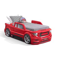 a red truck bed with checkered pillows on it