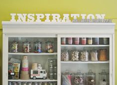 an open cabinet filled with lots of candy and candies on top of each shelf