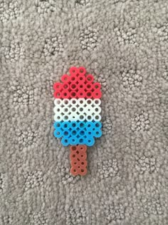 a plastic object made to look like an ice cream cone on the ground with holes in it