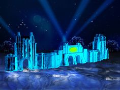 an ice castle with lights shining on it's sides and trees in the background