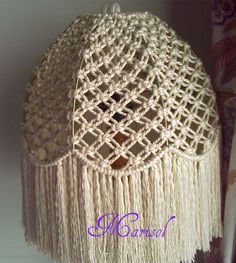 a close up of a hat with tassels on it