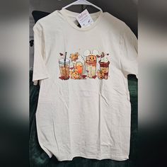 a white t - shirt with winnie the pooh and honey bears on it sitting on a green velvet surface