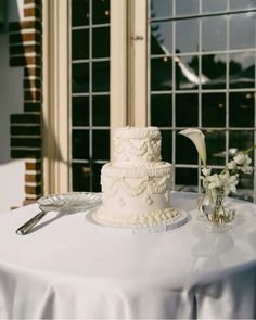 a white wedding cake sitting on top of a table