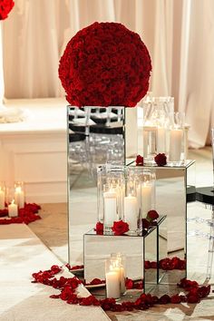 the centerpieces are filled with roses and candles