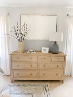 a wooden dresser sitting in front of a window