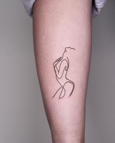 a woman's leg with a small tattoo on her left thigh, which has a line drawing of a dog