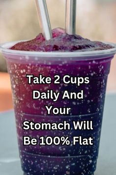 a cup with two straws in it and the words take 2 cups daily and your stomach will be 100 % flat