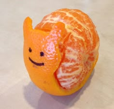 an orange with a smiley face drawn on it