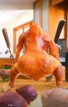 a chicken is standing on its hind legs in the kitchen