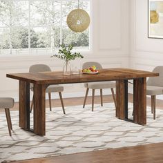 a dining room table with chairs and a vase on the table in front of it