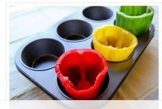 three muffin cups sitting on top of a tray filled with cupcake batters