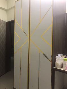 a room divider that has been painted white and gold