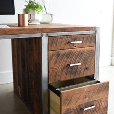 a wooden desk with two drawers and a computer monitor