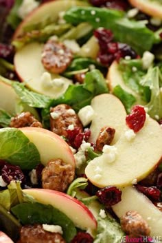 a salad with apples, cranberries and pecans on it is ready to be eaten