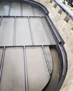 a skateboarder doing a trick on the side of a ramp