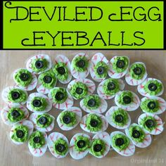 deviled egg eyeballs with green sprinkles and black eyes on them