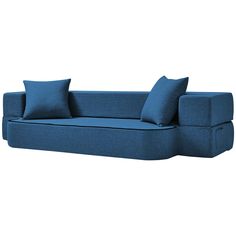 a blue couch with two pillows on it and one pillow is folded over the back