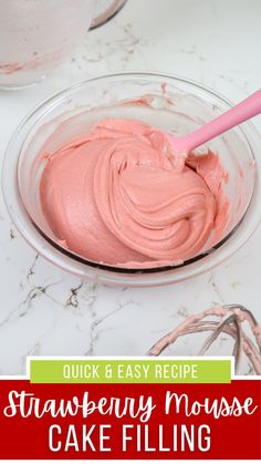 strawberry mousse cake filling in a glass bowl with a pink spoon on the side