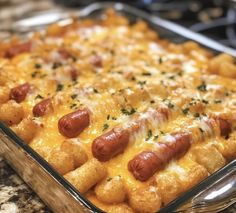 a casserole dish filled with cheesy tater tots and hot dogs