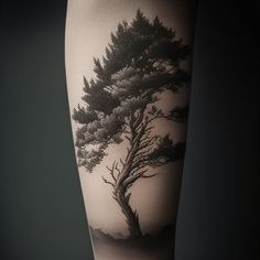 a black and white photo of a tree on the arm