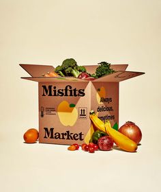 a cardboard box filled with fruits and vegetables