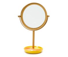 a round mirror sitting on top of a yellow stand