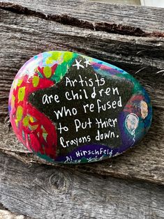 a painted rock with words written on it