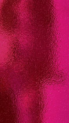 an abstract pink and red background that is very shiny with some light reflections on it