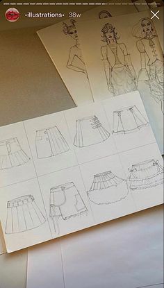 paper with drawings of different types of skirts on top of it, next to an envelope