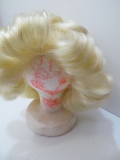 We are very pleased to offer for sale this vintage Kenner Blythe doll wig that dates back to 1972. This is the lemon color wig and it is in very good condition (tag inside says Made in Hong Kong) and is very soft and full. The wig comes with the original foam wig stand (the original owner drew a face in it in orange crayon (kind of adds whimsy to the piece).  These are not easily found and this will be a great addition to any Blythe collection! Foam Wigs, Wig Stand, Doll Wigs, Blythe Dolls, Hong Kong, Doll Toys, Toys Games, Action Figures, Wigs