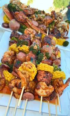 several skewers of food are lined up on a table