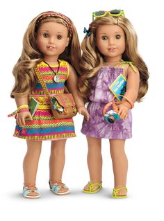 two dolls standing next to each other in front of a white background and one is holding a camera