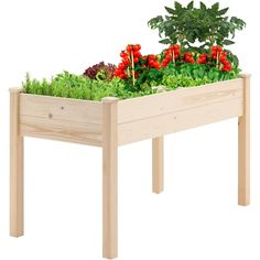 a wooden planter filled with lots of green and red flowers on top of a white background