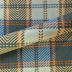 a blue, orange and white plaid fabric with an interesting design on it's side