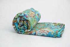 two pieces of fabric folded together on top of each other in different colors and patterns