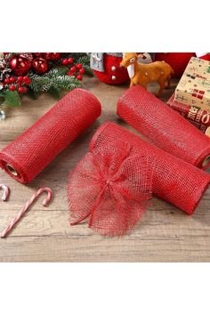 red mesh wrapped presents with candy canes on wooden table