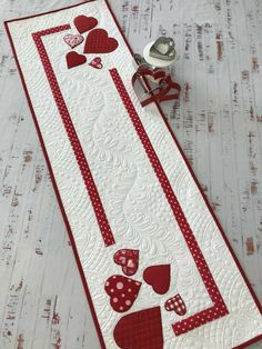 a red and white table runner with hearts on it