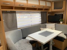 the inside of a motor home with couches and tables