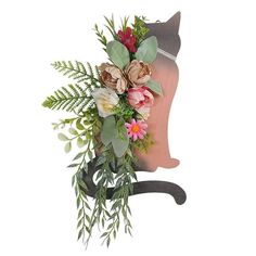 a cat head with flowers and greenery on it