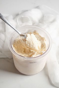 an ice cream in a plastic container with a spoon