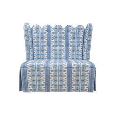 a blue and white chair with an ornate pattern on the back, sitting against a white background