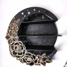 a wooden moon with flowers and stars on it