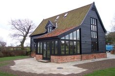 a large black building with lots of windows on the front and side of it's roof