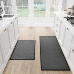 two mats in the middle of a kitchen floor