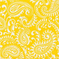 a yellow and white paisley print fabric on a measuring tape with a ruler in the foreground