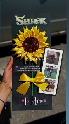 a person holding up a card with a sunflower on it and an advertise